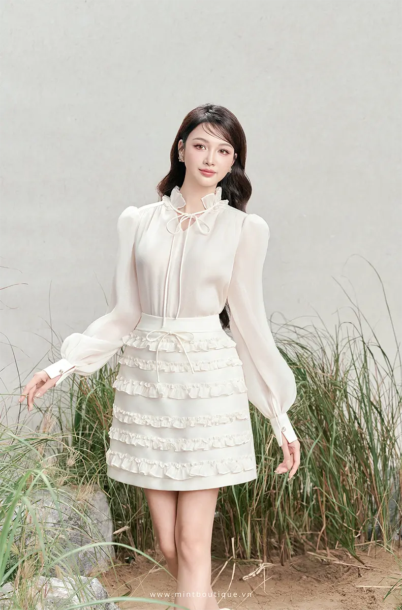 Chân váy A tafta kem kê bèo tầng nơ chỉ kem